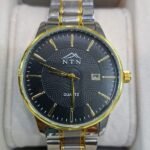 Elegant men's black dial chronograph watch with gold accents and metal strap.