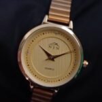 Elegant women's watch with a golden dial and steel strap. Perfect for stylish and professional looks.