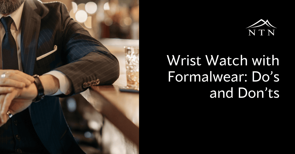 Close-up of a stylish man wearing a formal wristwatch, demonstrating proper wristwatch etiquette for formalwear settings.
