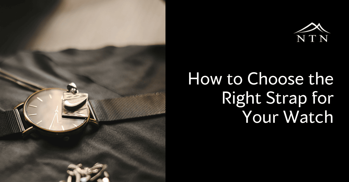 Close-up of a stylish watch with a black strap laid on fabric, showcasing different strap options for watches.