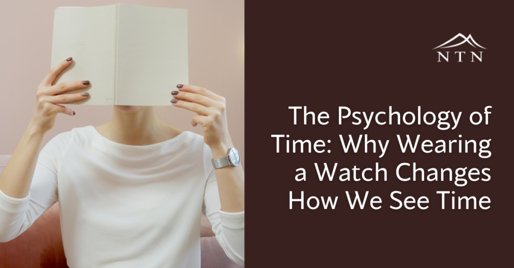 A person holding an open watch to their face, exploring how wearing watches influences our perception of time.