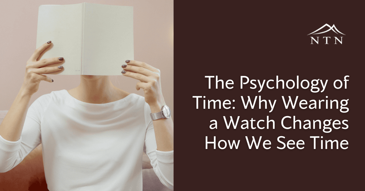 A person holding an open watch to their face, exploring how wearing watches influences our perception of time.