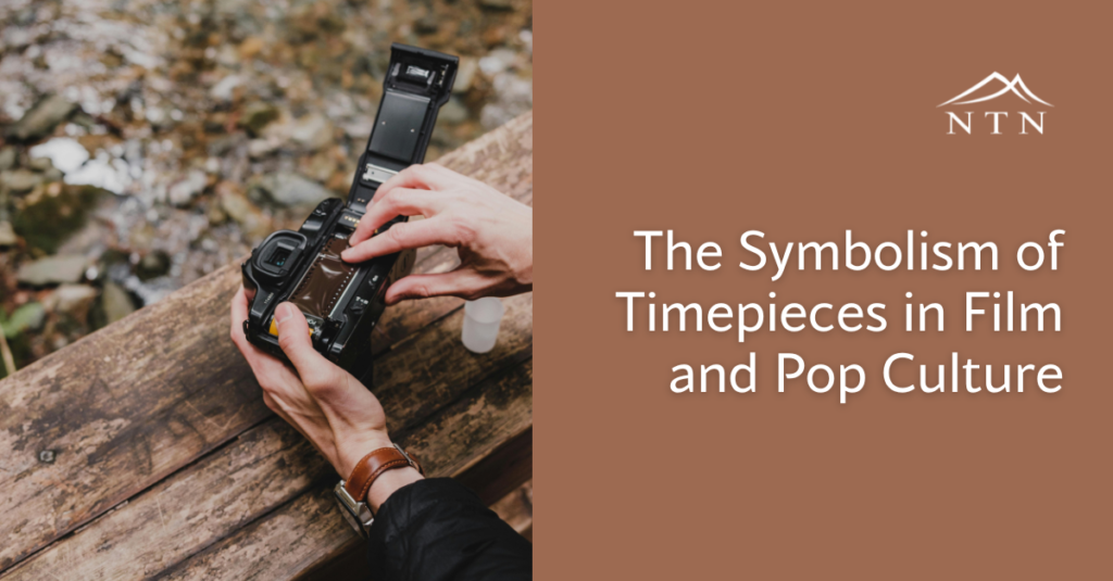 Hand holding a camera with a clock symbol, symbolizing timepieces in film.